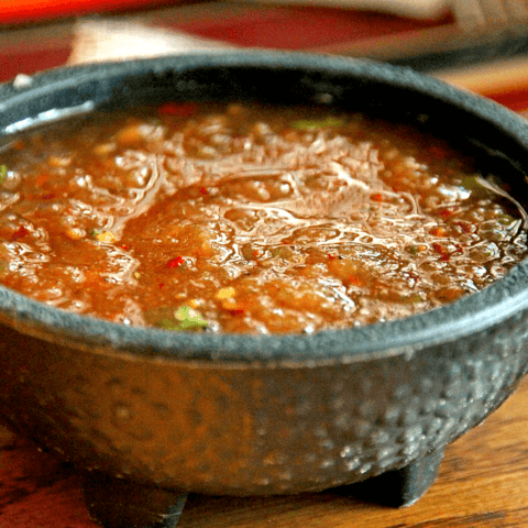 Vibrant homemade sauce in a rustic bowl, perfect for dipping or enhancing your favorite dish.