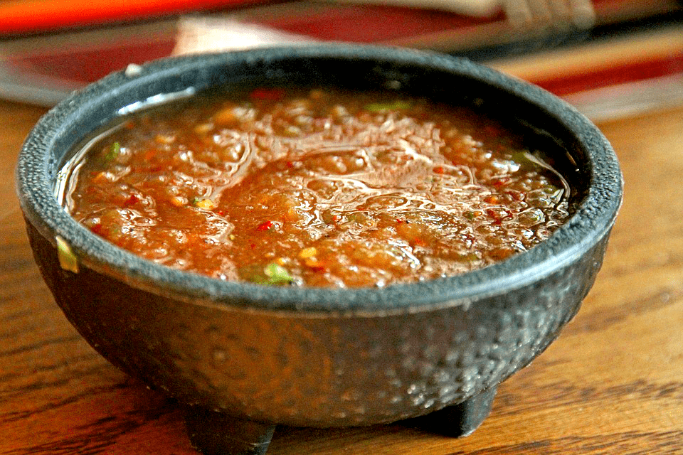Vibrant homemade sauce in a rustic bowl, perfect for dipping or enhancing your favorite dish.