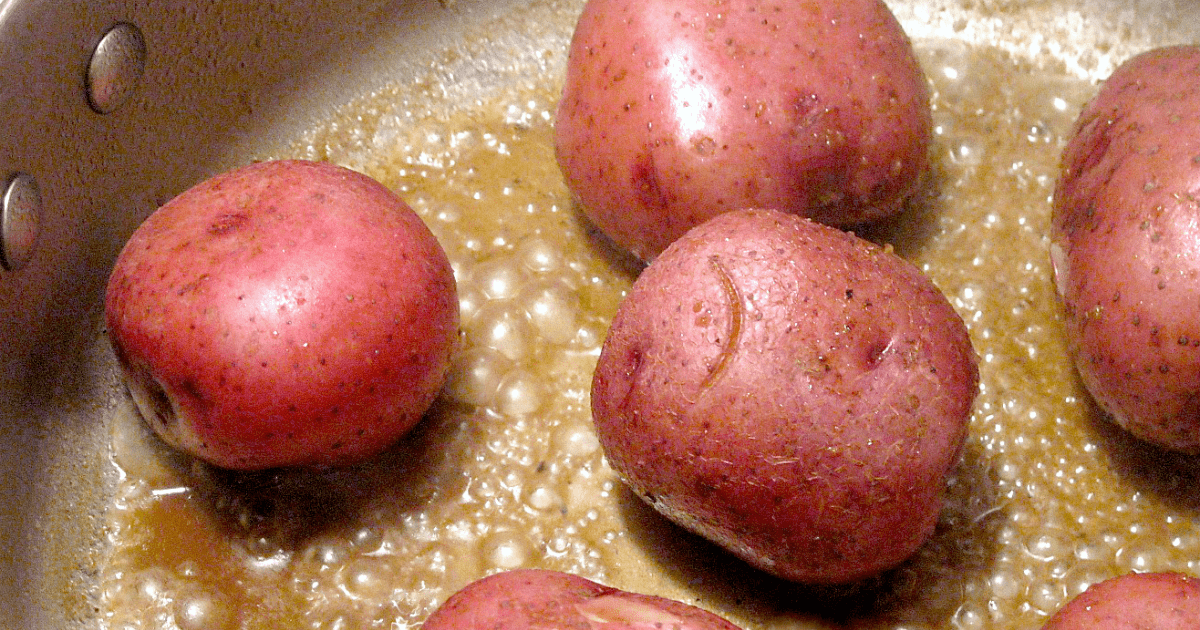 Sizzling red potatoes frying in golden oil, perfect for a cozy home-cooked meal.