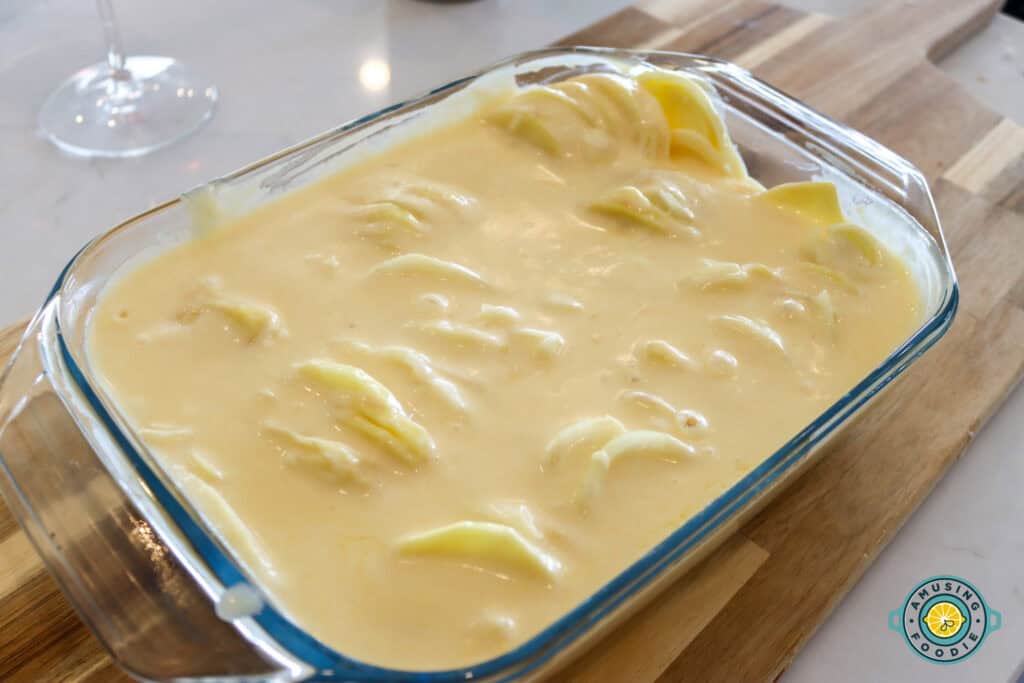 creamy scalloped potatoes on glass tray