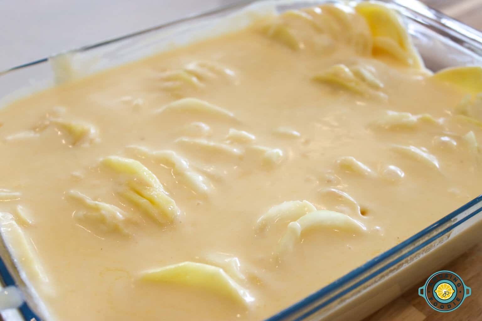 creamy scalloped potatoes on glass tray