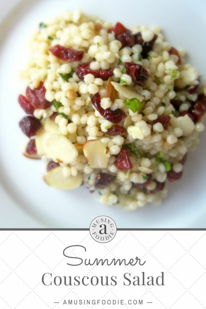 A single serving of pearl couscous salad with sliced almonds, dried cranberries and fresh basil.