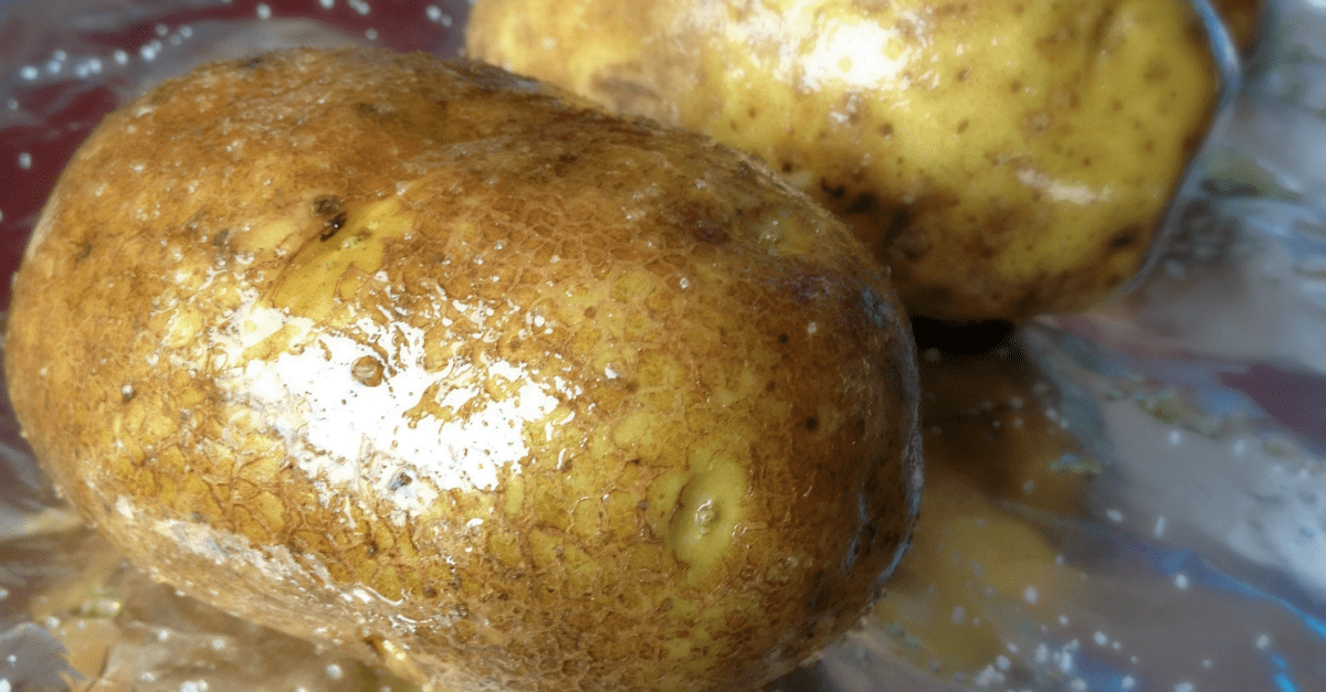Rustic potatoes on foil, ready for baking and seasoning for delicious, comforting flavor.
