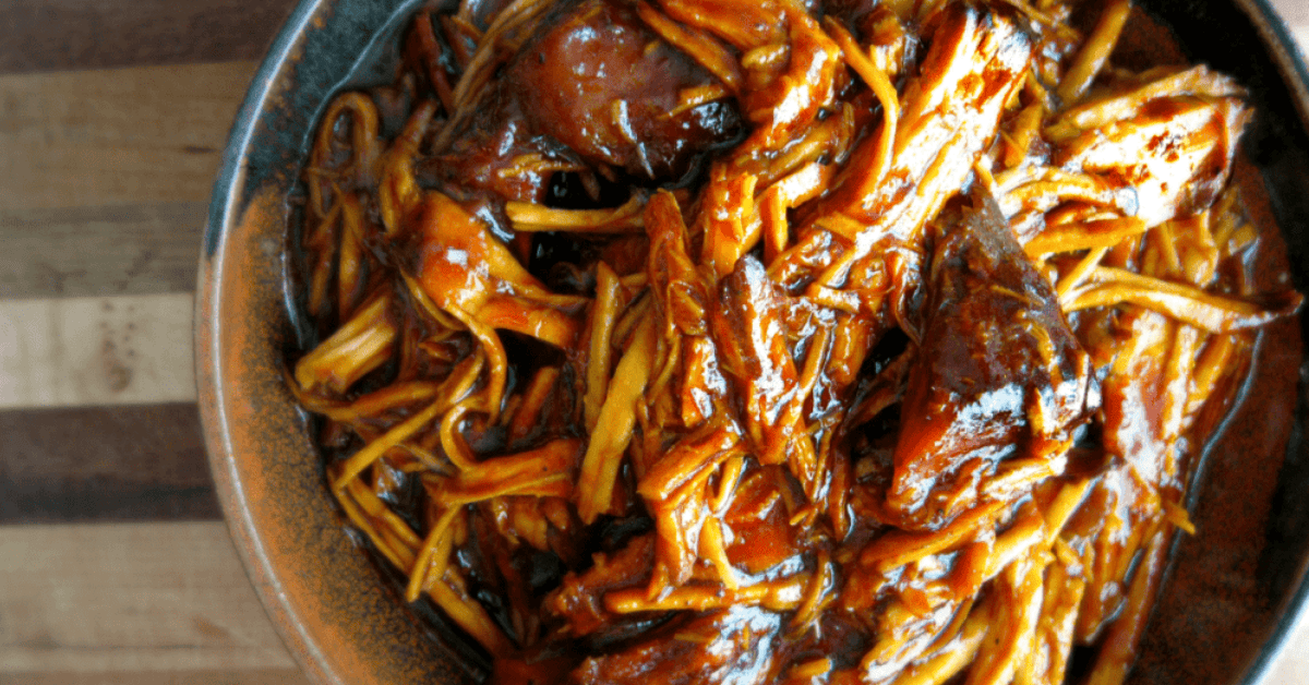 Savory slow-cooked pork noodles in rich sauce, perfect for a comforting meal.