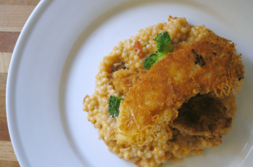 Chicken tender sitting on couscous