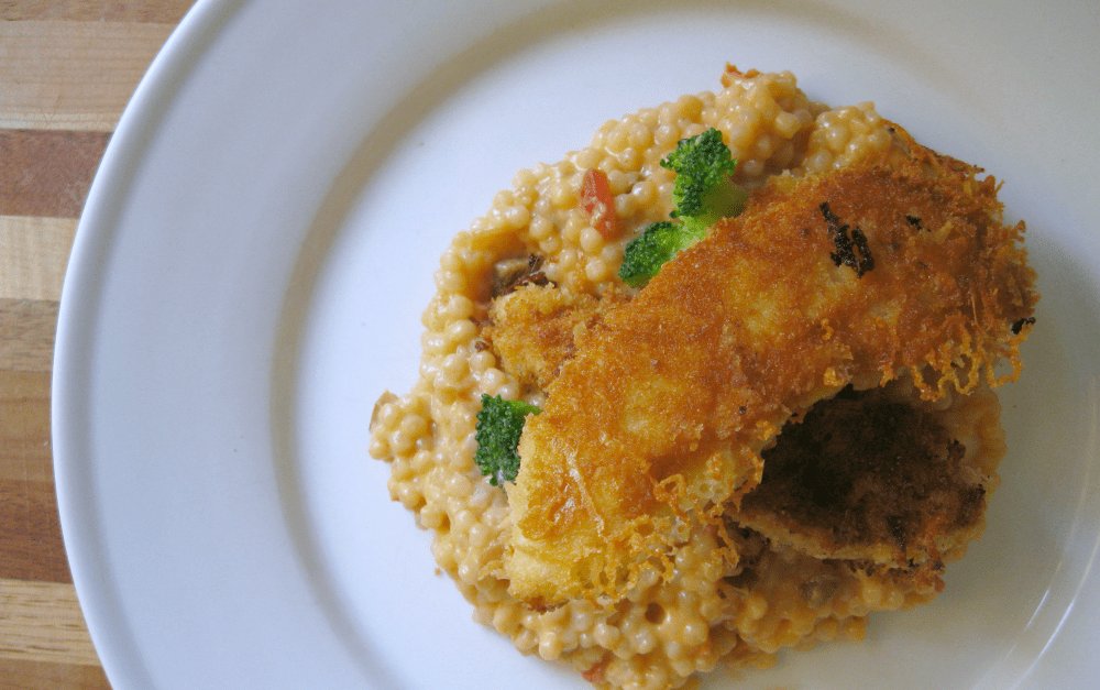 Chicken tender sitting on couscous
