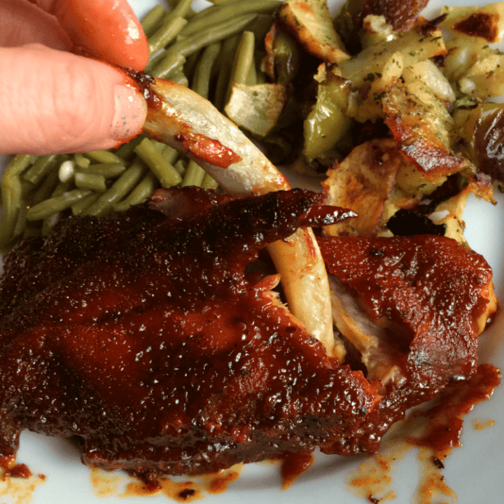 Savory BBQ ribs served with vibrant green beans and crispy roasted potatoes.