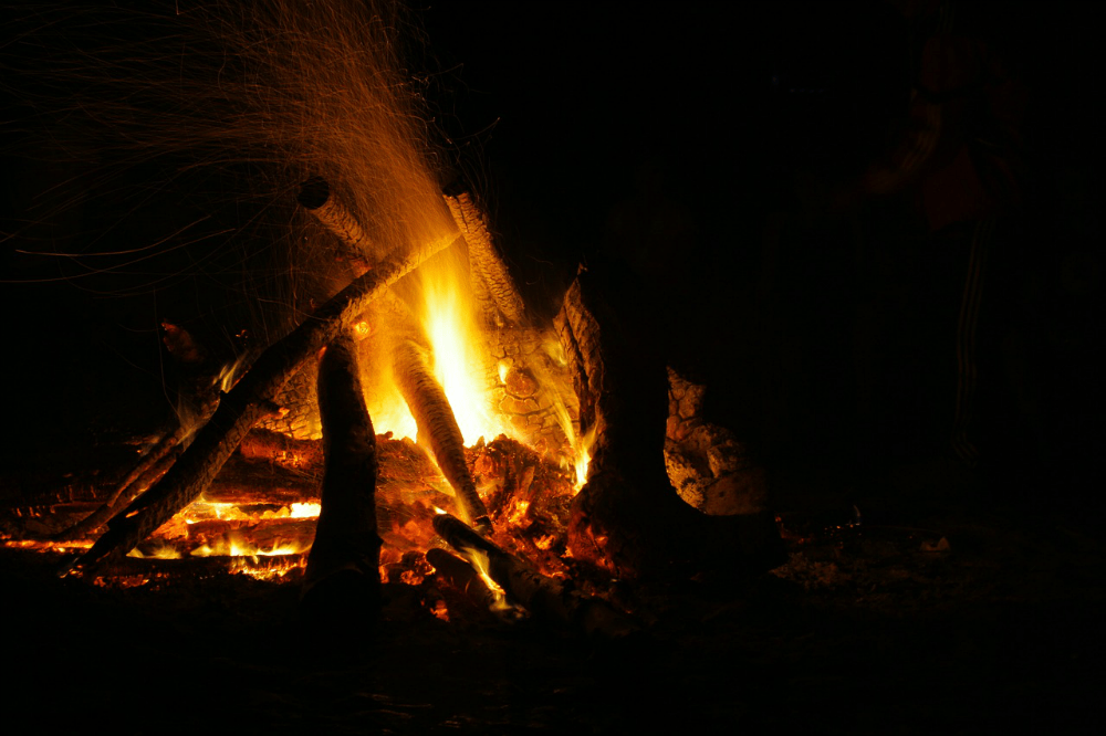 Large campfire at night when it's dark.
