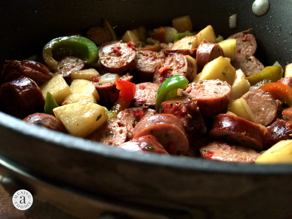 Sauteed chicken sausage, apples and peppers in a pan.