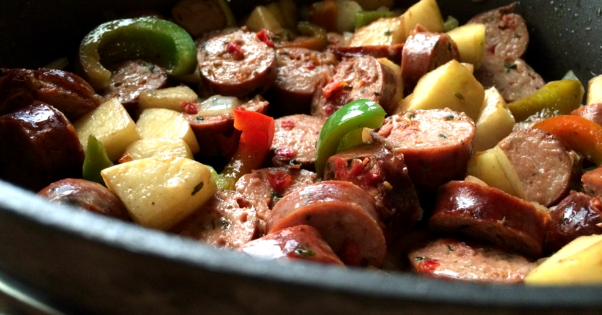 Sauteed chicken sausage, apples and peppers in a pan.