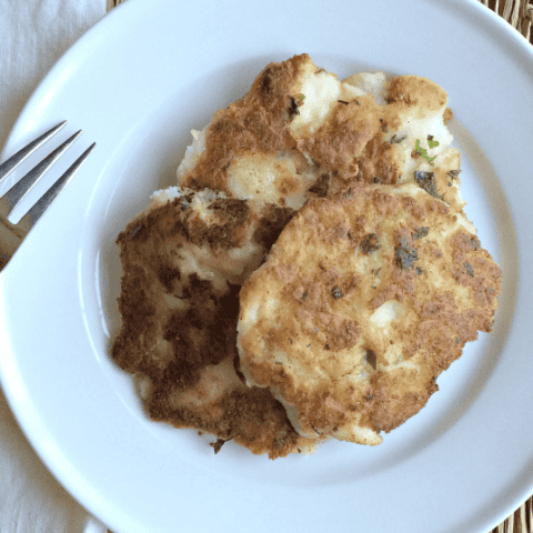 Delicious golden fritters served on a white plate, perfect for any homemade meal.
