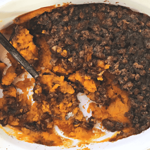 Irresistible sweet potato casserole topped with a crunchy nut mixture for ultimate comfort.