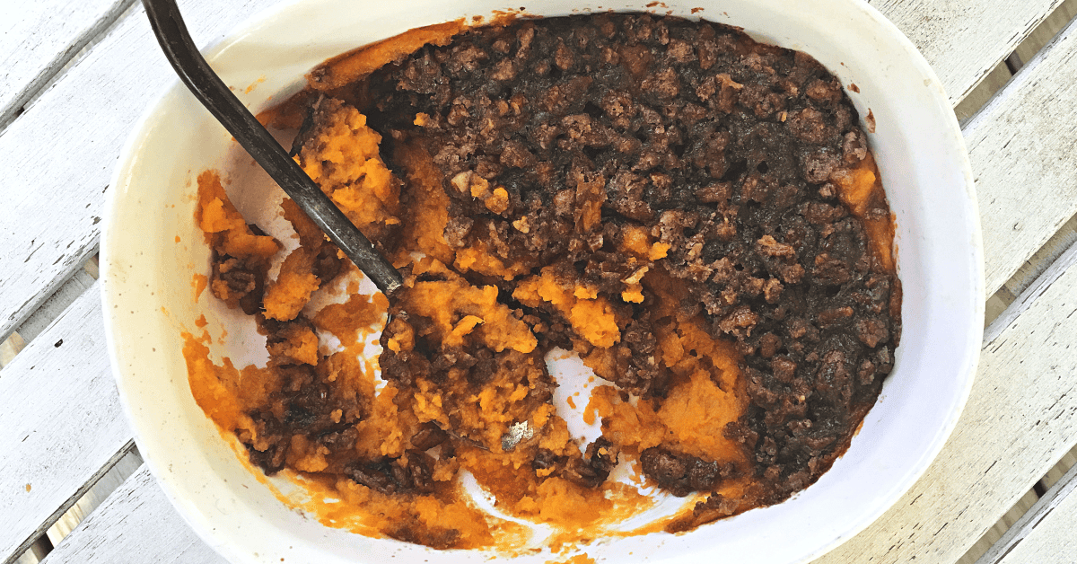 Irresistible sweet potato casserole topped with a crunchy nut mixture for ultimate comfort.