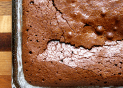 Freshly baked rich and chewy cocoa brownies in a glass baking pan.