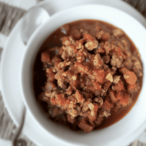 Delicious meat sauce in a white bowl, perfect for cozy gatherings and comfort food moments.