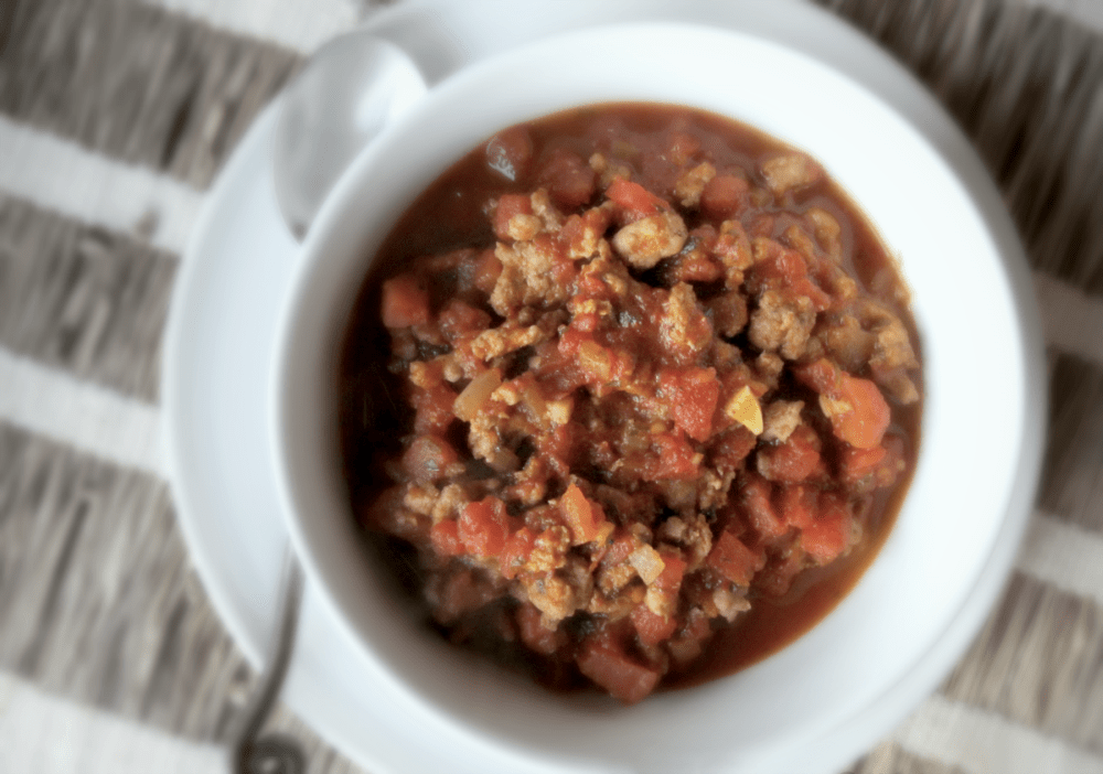 Delicious meat sauce in a white bowl, perfect for cozy gatherings and comfort food moments.