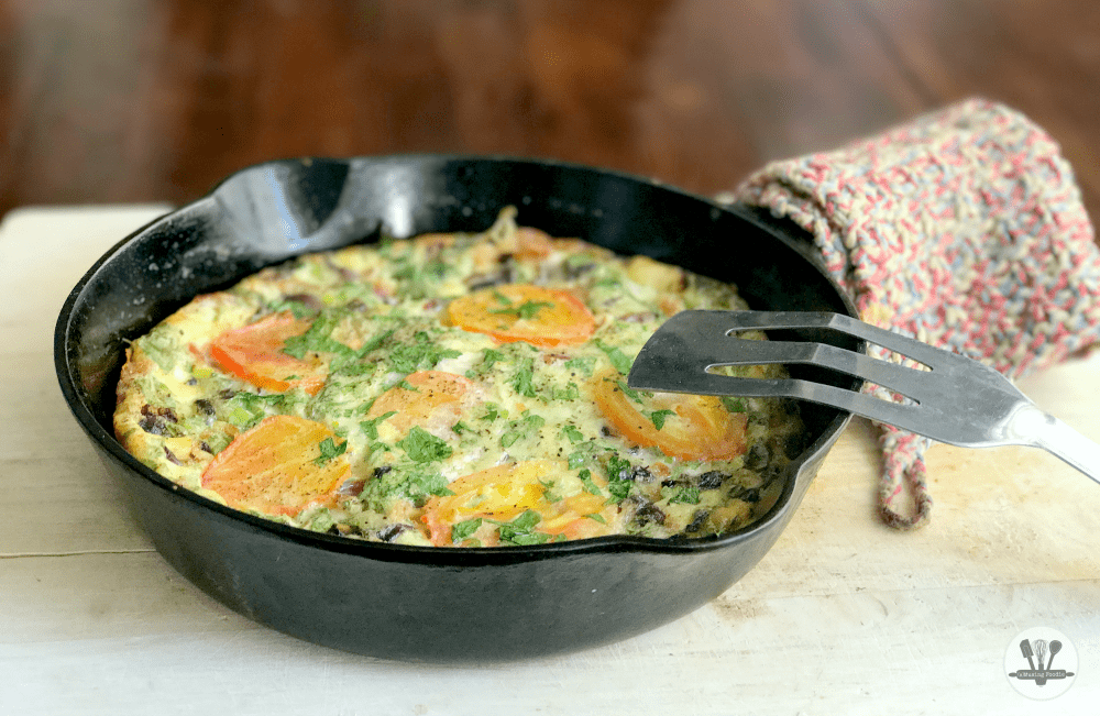 This savory crustless quiche for two is perfect for brunch (or dinner)! It's simply made, with Nellie's® Free Range Eggs, two kinds of cheddar from the Cabot® Creamery co-op of Vermont farm families, bacon, parsley and an assortment of veggies—including organic mushrooms, green onions and ripe heirloom tomatoes from the garden (or from your local farmers' market).