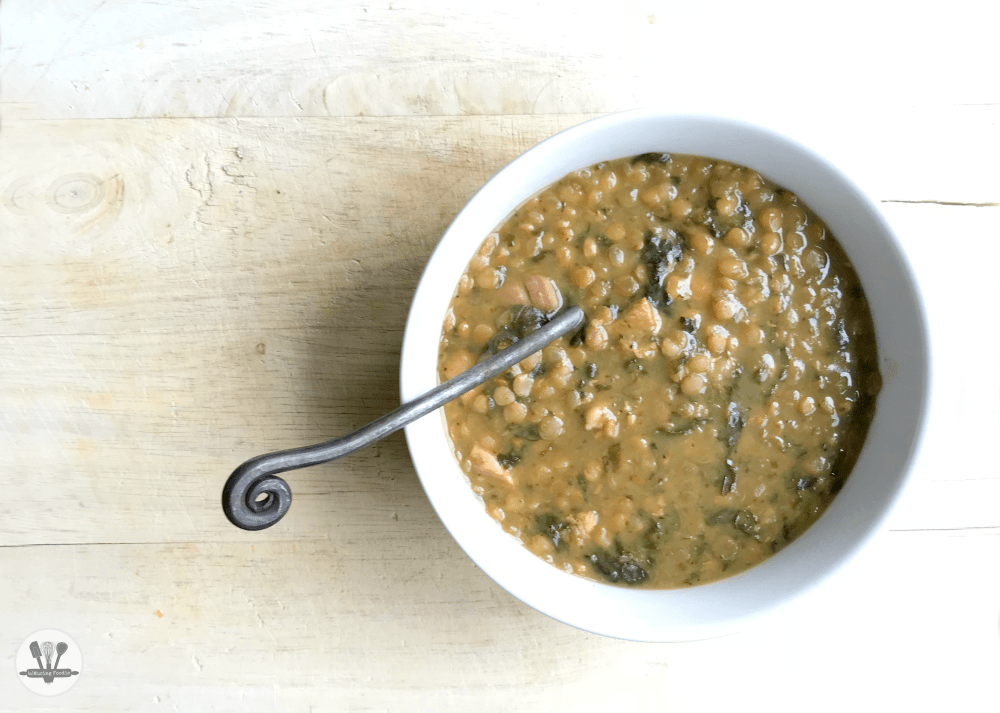 Bowl of simple chicken and lentil soup made in the Instant Pot. A hearty meal that'll warm you to the bone!