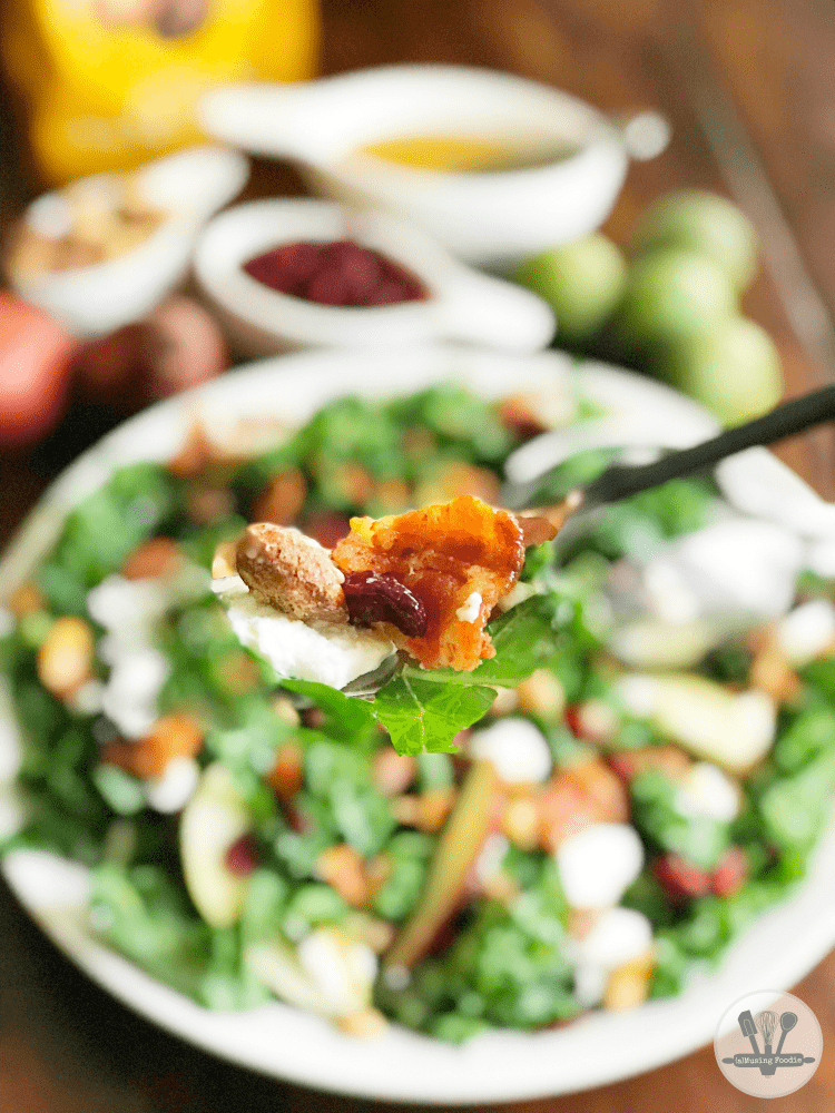 This winter kale salad is topped with Sahale Snacks Honey Almonds Glazed Mix, full of dried cranberries, sliced red pears, crispy bacon, honey goat cheese and a hint of lime juice. A simple homemade honey mustard dressing drizzled on top adds a final sweet and savory note. Yum!
