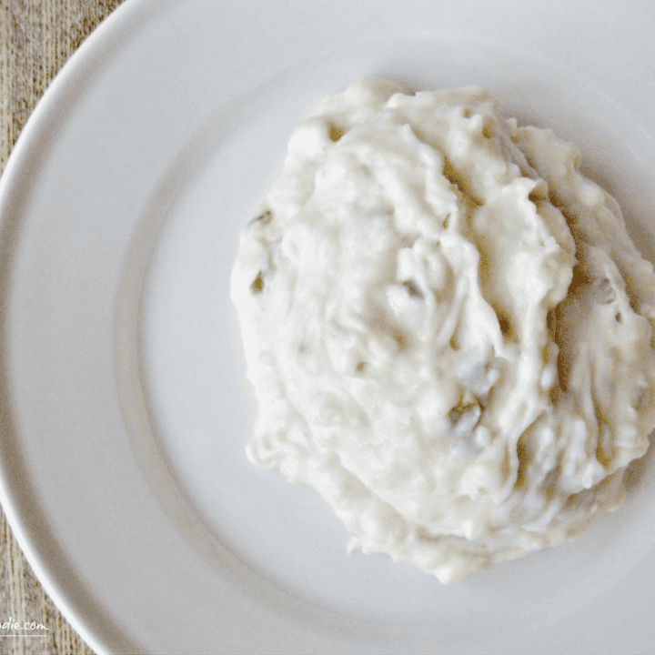 Delicious creamy mashed potatoes served on a rustic white plate, perfect for comfort food lovers.