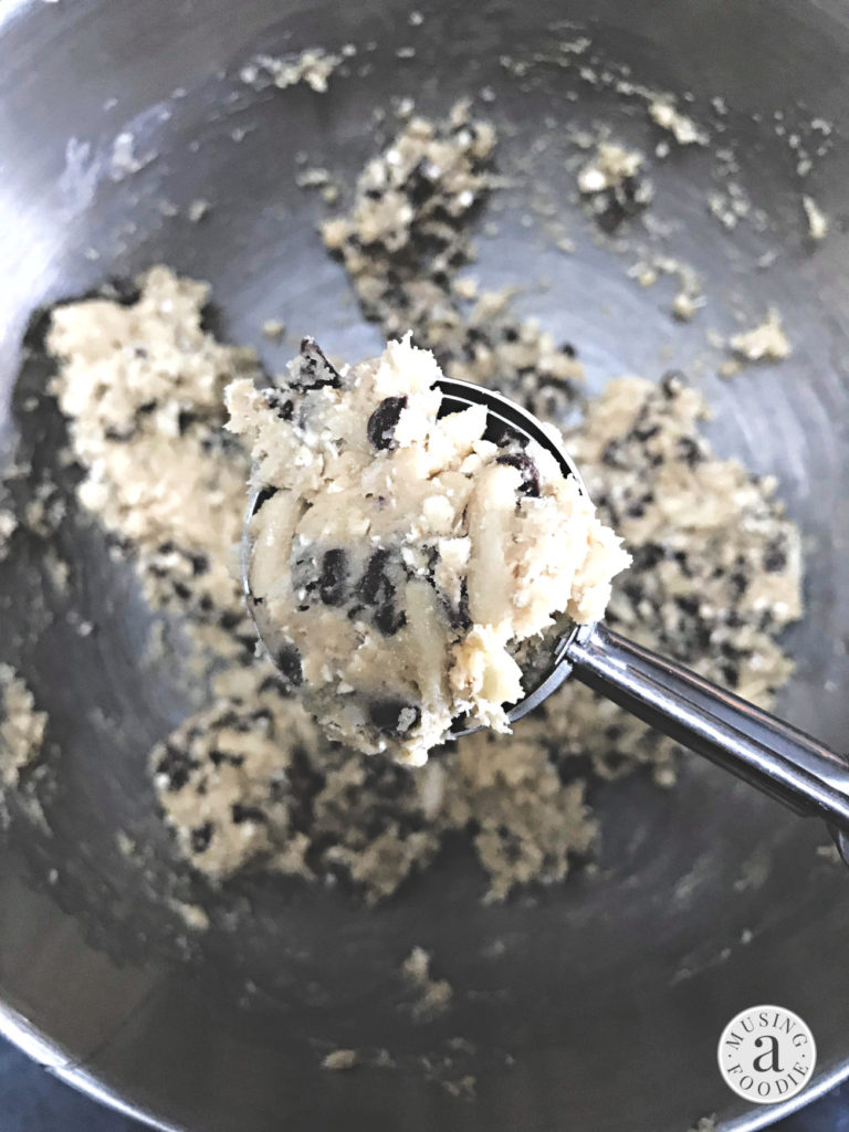 A scoop of oatmeal chocolate chip cookie dough with almonds.