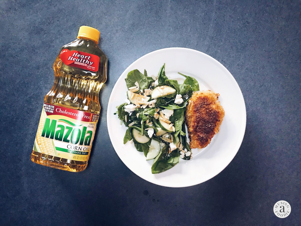 Panko crusted chicken with spinach salad and homemade vinaigrette pictured with Mazola Corn Oil.